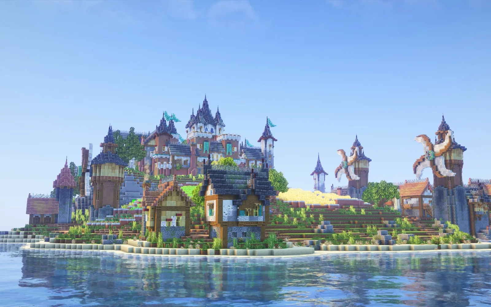 A Minecraft island kingdom of towers, houses and windmills, seen across the water.